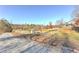 View of property with dirt road, fencing, and wooded area, perfect for outdoor adventures at 3975 Mcconnell Rd, Cumming, GA 30028