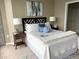 Comfortable bedroom features a geometrically patterned headboard, soft textures and a large painting adding a touch of elegance at 855 Peachtree Ne St # 2306, Atlanta, GA 30308