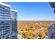 A beautiful city view with bright blue sky and a colorful forest in the distance taken from a high-rise balcony at 855 Peachtree Ne St # 2306, Atlanta, GA 30308