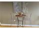 Minimalist dining area with transparent chairs and modern artwork, creating a chic ambiance at 855 Peachtree Ne St # 2306, Atlanta, GA 30308