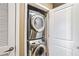 Efficient laundry closet with a stacked washer and dryer set, perfect for saving space in your home at 855 Peachtree Ne St # 2306, Atlanta, GA 30308