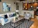 Comfortable living room adjacent to the kitchen with modern furniture and stylish decor at 855 Peachtree Ne St # 2306, Atlanta, GA 30308