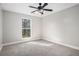 Cozy bedroom with carpet, a ceiling fan, and a window allowing plenty of natural light at 1312 Buttercup Ct, Lawrenceville, GA 30044