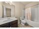 Cozy bathroom with a single vanity, toilet, and shower-tub combination featuring a patterned shower curtain at 678 Emeril Dr, Avondale Estates, GA 30002