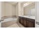 Bathroom featuring double vanity, large tub, and tiled floors at 678 Emeril Dr, Avondale Estates, GA 30002
