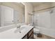 Bright bathroom featuring a vanity with sink, toilet, and a bathtub-shower combination with white tiles at 678 Emeril Dr, Avondale Estates, GA 30002