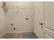 Neutral laundry room with tile floor and shelving, ready for appliance hookups and efficient organization at 678 Emeril Dr, Avondale Estates, GA 30002