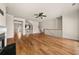 Open-concept living room with hardwood flooring, a ceiling fan, a fireplace, and natural lighting at 678 Emeril Dr, Avondale Estates, GA 30002