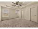 Large carpeted main bedroom with tray ceiling, ceiling fan, and natural light at 678 Emeril Dr, Avondale Estates, GA 30002