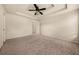 Main bedroom with carpet, tray ceiling, and a ceiling fan at 678 Emeril Dr, Avondale Estates, GA 30002