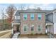 Charming brick townhome with inviting entryway, black front door with wreath and neatly landscaped front yard at 691 Cordele Ln, Sugar Hill, GA 30518