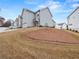 View of the side of townhomes showing a side entrance with two-car garages and landscaped surroundings at 691 Cordele Ln, Sugar Hill, GA 30518