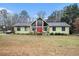 Inviting single-Gathering home featuring a red front door and beautiful stonework accents at 275 Helen Ln, Stockbridge, GA 30281