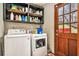 Practical laundry room with a washer, dryer, and convenient shelving at 275 Helen Ln, Stockbridge, GA 30281