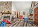 Cozy living room with a stone fireplace and stylish wood-look floors at 275 Helen Ln, Stockbridge, GA 30281