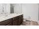 Bathroom featuring a double sink vanity with dark wood cabinets and a separate shower at 4192 Integrity Way, Powder Springs, GA 30127