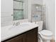 Bright bathroom features a white vanity, a shower with curtain, and shelving for storage at 4192 Integrity Way, Powder Springs, GA 30127