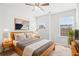 Bedroom with light wood furniture, including a bed and nightstands, and natural light from two windows at 4192 Integrity Way, Powder Springs, GA 30127