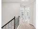 Bright hallway with carpeted floors, doors to rooms, and railing at 4192 Integrity Way, Powder Springs, GA 30127