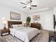 Bright main bedroom with modern decor, a ceiling fan, tray ceiling and cozy rug at 4192 Integrity Way, Powder Springs, GA 30127
