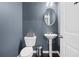 Stylish powder room with gray walls, pedestal sink and modern fixtures at 4192 Integrity Way, Powder Springs, GA 30127