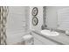 Clean bathroom with tub, shower, toilet, vanity with gray countertop, and stylish mirror at 142 Oakchase Park Ln, Hampton, GA 30228