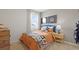 Well lit bedroom with sports themed décor, neutral walls, and carpeted flooring at 142 Oakchase Park Ln, Hampton, GA 30228