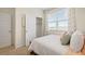 Well-lit bedroom with white trim and neutral carpet. Includes a view from the window at 142 Oakchase Park Ln, Hampton, GA 30228