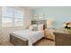 Charming bedroom with large window, bed with decorative pillows and a stylish nightstand at 142 Oakchase Park Ln, Hampton, GA 30228