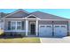 Charming single-Gathering home with a two-car garage, gray siding, and a well-manicured front lawn at 142 Oakchase Park Ln, Hampton, GA 30228