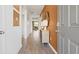 Inviting hallway with hardwood floors and stylish decor leading to the dining and living area at 142 Oakchase Park Ln, Hampton, GA 30228