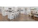 Modern kitchen features granite countertops, stainless appliances, and a large island with seating at 142 Oakchase Park Ln, Hampton, GA 30228