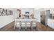 Bright kitchen showcasing a large island with seating, granite countertops and stainless steel appliances at 142 Oakchase Park Ln, Hampton, GA 30228