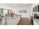 Open concept kitchen and dining area, featuring stainless steel appliances and a large island at 142 Oakchase Park Ln, Hampton, GA 30228