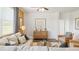 Cozy living room featuring hardwood floors, modern furniture, and large windows at 142 Oakchase Park Ln, Hampton, GA 30228