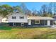 Charming home with a dark gray and white exterior, metal roof, and a well-maintained front yard at 2793 Heritage Ln, Morrow, GA 30260