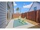 Cozy backyard patio with two green Adirondack chairs on a striped rug and wood fence at 1416 Lucan Ln # Wc220, Lawrenceville, GA 30043