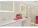 Well-lit bathroom featuring dual sinks, illuminated mirrors, and walk-in shower at 1416 Lucan Ln # Wc220, Lawrenceville, GA 30043