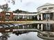 Contemporary building exterior reflected in water, showcasing modern architecture and surrounding greenery at 1416 Lucan Ln # Wc220, Lawrenceville, GA 30043