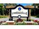 City of Lawrenceville sign with flowers, greenery, and rustic wood frame at 1416 Lucan Ln # Wc220, Lawrenceville, GA 30043