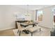 Bright dining room with a dark wood table, bench seating, and decorative buffet at 1416 Lucan Ln # Wc220, Lawrenceville, GA 30043