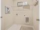 Bright laundry room with wire shelving and tile flooring for easy cleaning at 1416 Lucan Ln # Wc220, Lawrenceville, GA 30043