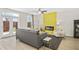 Contemporary living room with a striking yellow accent wall, modern fireplace, and French doors at 1416 Lucan Ln # Wc220, Lawrenceville, GA 30043