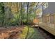 A view of the backyard with trees, lush greenery, and a wooden fence at 60 Newcastle Sw St, Atlanta, GA 30314
