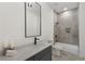 Modern bathroom with gray tiled shower/tub and a sleek vanity with a large mirror at 60 Newcastle Sw St, Atlanta, GA 30314