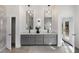 Modern bathroom with double sink vanity, stone tile accent wall, and backyard access at 60 Newcastle Sw St, Atlanta, GA 30314