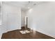Spacious bedroom featuring dark hardwood floors, tray ceilings, and a large closet at 60 Newcastle Sw St, Atlanta, GA 30314