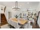 Elegant dining area with a modern chandelier, hardwood floors, and an open view to the living room at 60 Newcastle Sw St, Atlanta, GA 30314