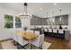 Bright dining room with a stylish chandelier, hardwood floors, and a seamless flow into the modern kitchen at 60 Newcastle Sw St, Atlanta, GA 30314
