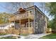 Exterior of two-story home with gray siding, wood balconies, and a concrete driveway at 60 Newcastle Sw St, Atlanta, GA 30314